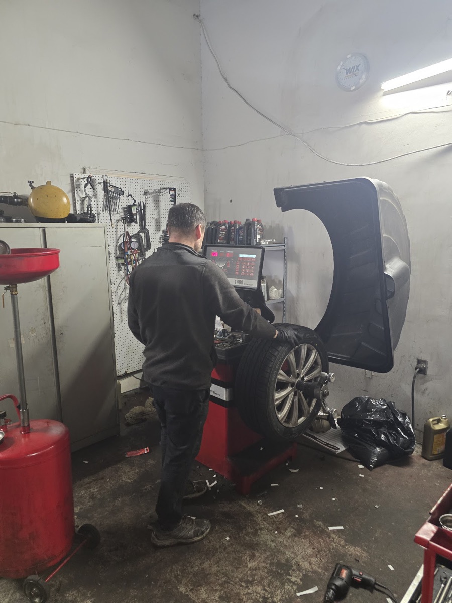 A technician balancing a wheel at ATL Mobile Auto Repair